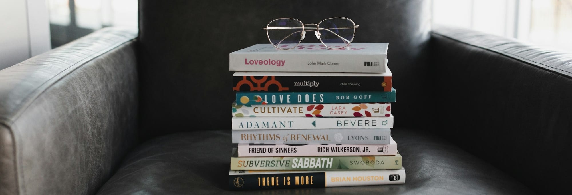 assorted books on black couch